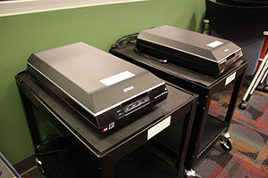 Two Epson V600 Scanners on roll-up carts.