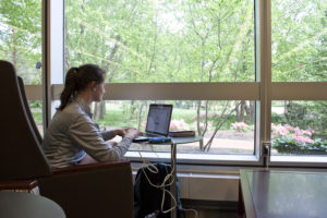 Student by the window in the Reading Room
