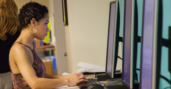 Student using a computer in Morris Library to conduct research