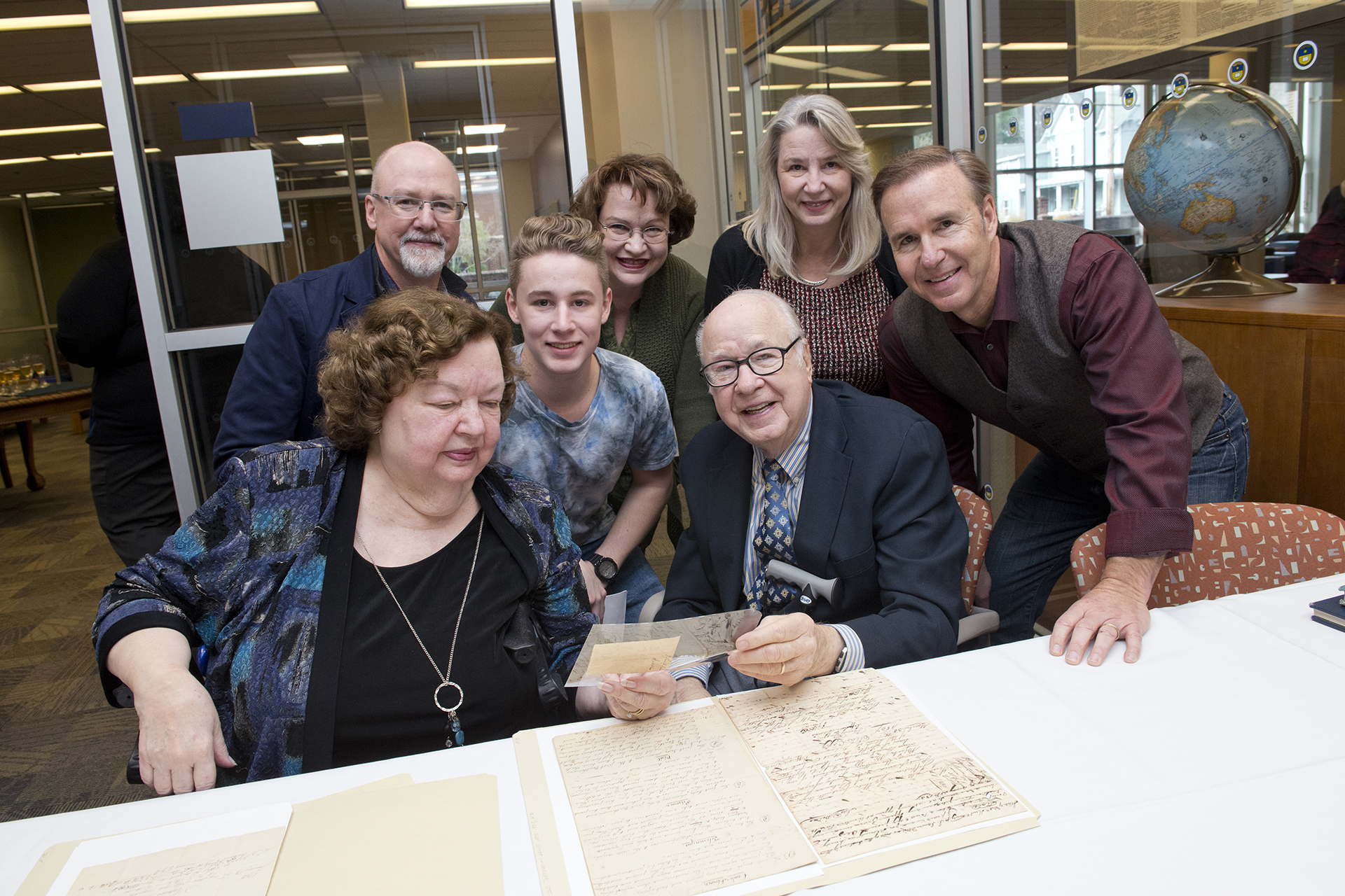 The Lewis family examining objects from the their family papers.