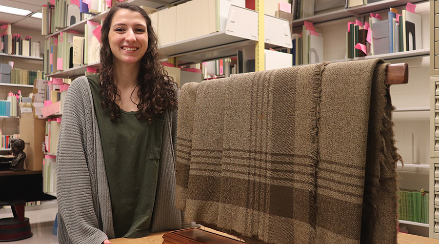 Claire Armann posing next to Abraham Lincoln's blanket.