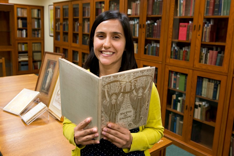 Tara Contractor, a doctoral candidate from Yale University’s History of Art Department, holds a book from the University of Delaware’s Mark Samuels Lasner Collection. As recipient of this year’s Amy P. Goldman Fellowship in Pre-Raphaelite Studies, Contractor has been using the University’s collections as well as materials from the Delaware Art Museum for research during her fellowship residency.