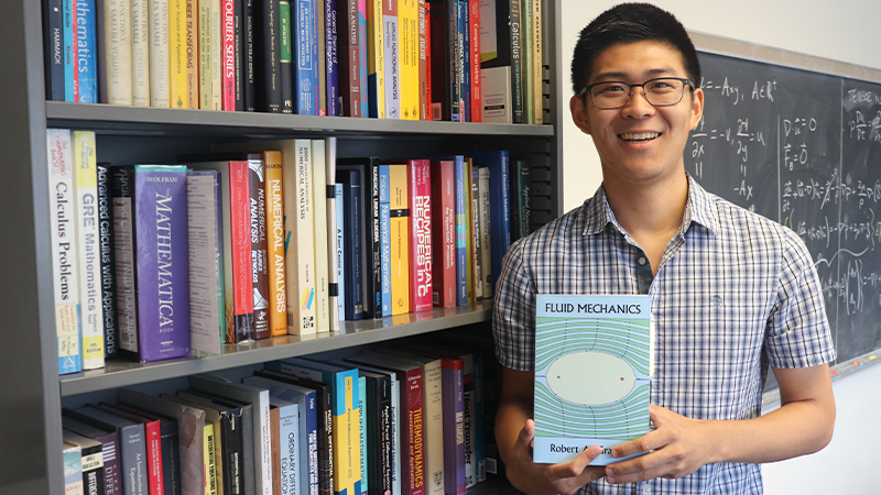 Joseph Nakao with his book collection