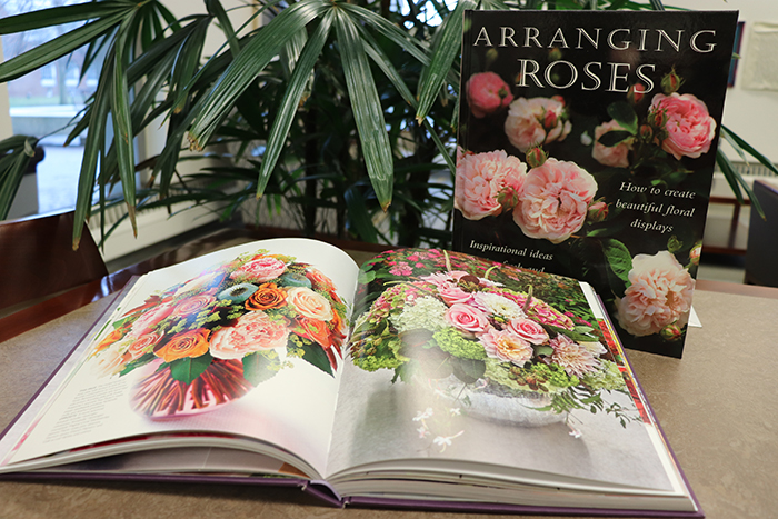 Books on flower arranging displayed on a table.