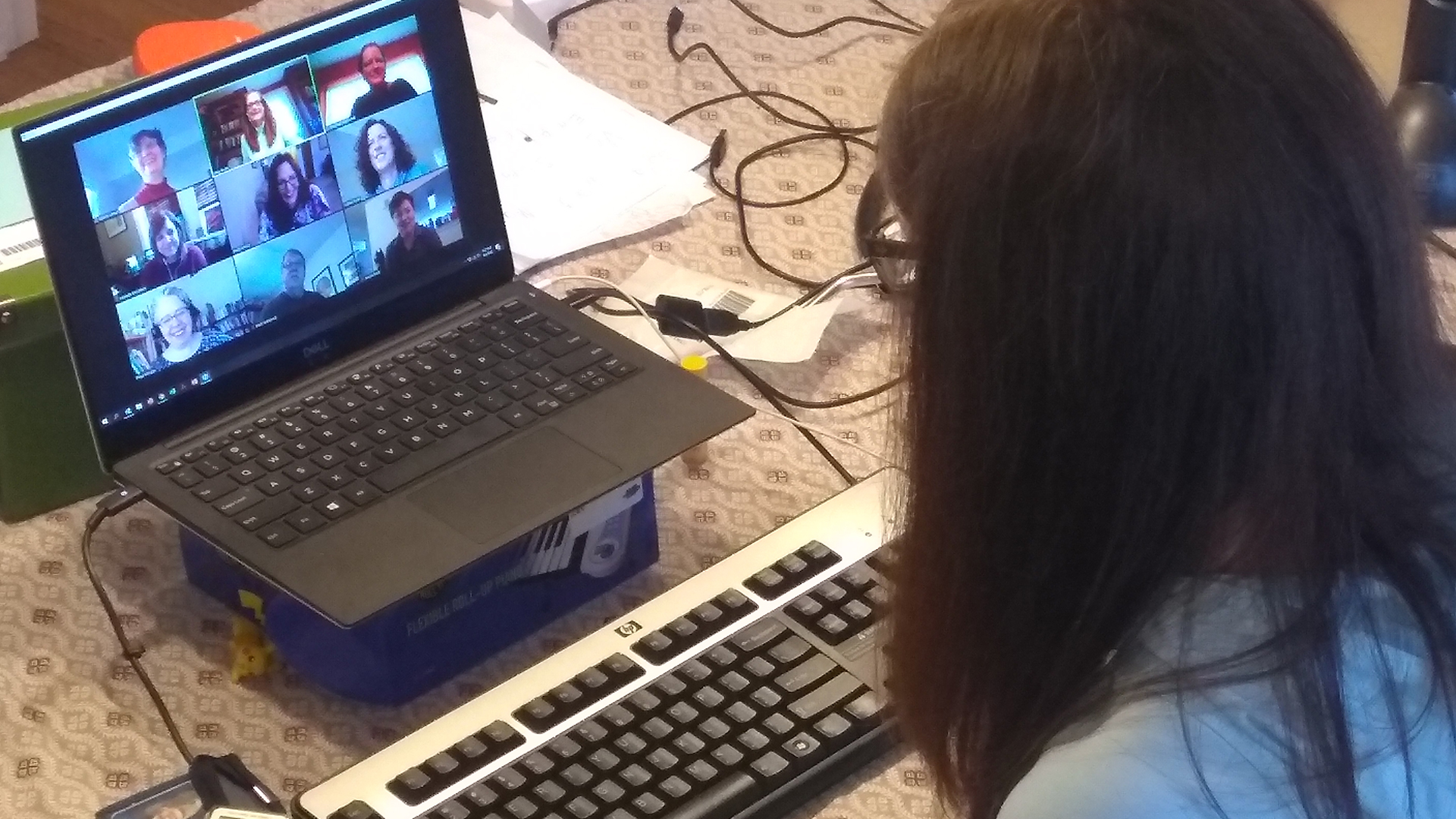 Librarian Meg Grotti on her laptop for a Zoom call with her colleagues