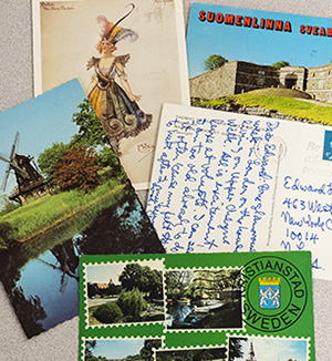 A group of five postcards with bright designs and handwritten messages.