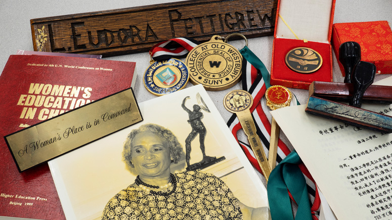 A collage of medals, letter openers, stamps, books, photos, name plates and notes.