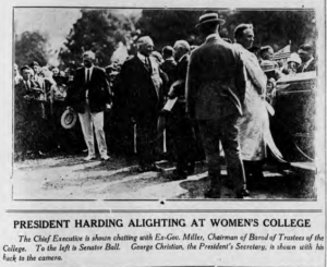 A newspaper clipping featuring a photo of President Warren G. Harding with the headline that reads, "President Harding Alighting at Women's College"
