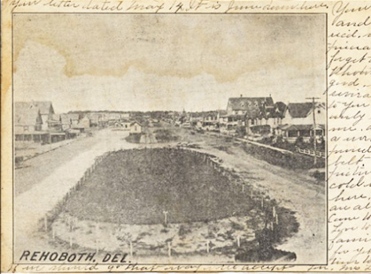 A black-and-white postcard showing another view of the main dirt road of Rehoboth