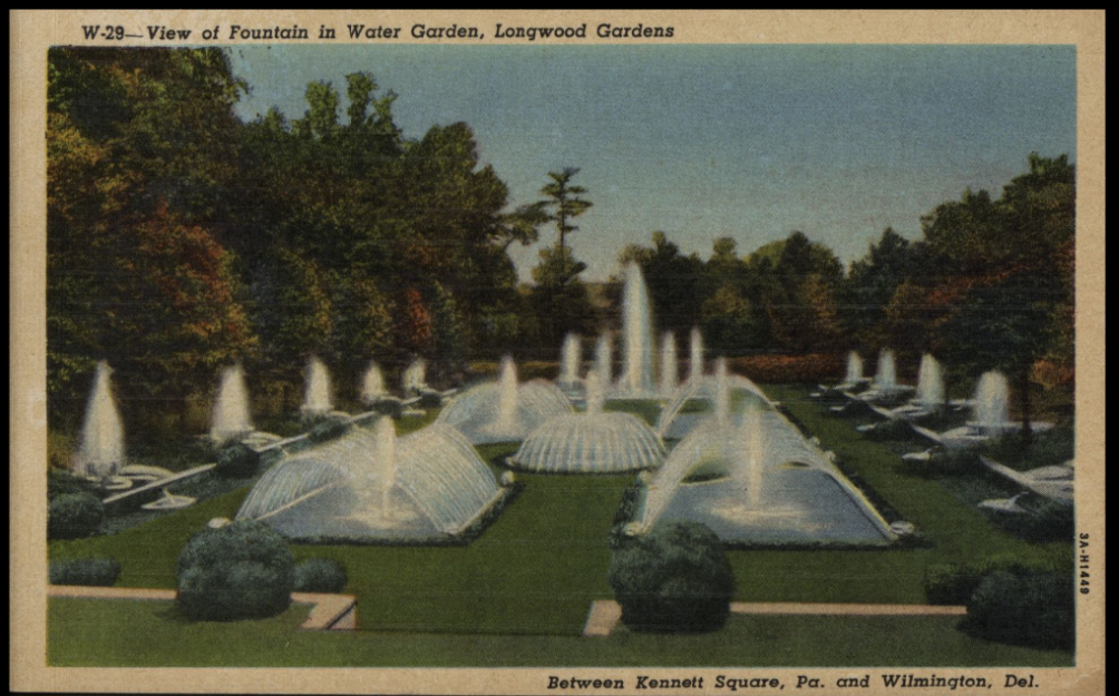 A postcard showing grand fountains throughout a green space