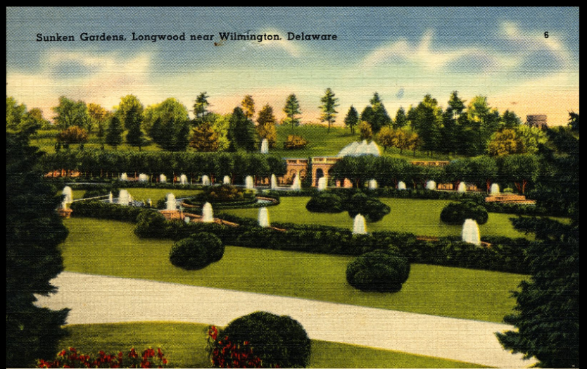 A postcard showing a garden with shrubs and fountains