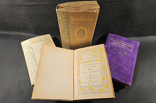 Clockwise from the top, copies of The Girl Graduate belonging to Lloyd, Gibbins, MacDaniel, and Baillie. Gibbins’ book is a deluxe edition bound in purple ooze leather, while the other three are standard editions with quarter cloth bindings and paper-covered boards.