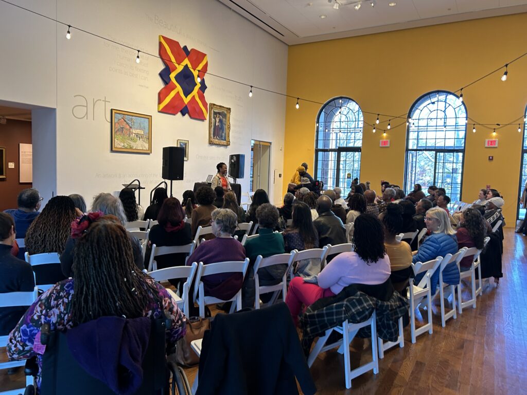 Dr. Currie emcees the Winter Nights Poetry Celebration Featuring Poetic Roots event at the Delaware Art Museum on March 21, 2024.