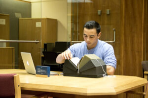 Researcher examining a rare book in the Special Collections Reading Room