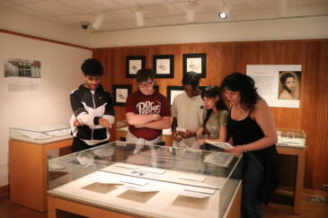 Group of visitors viewing an exhibition in the Special Collections Gallery