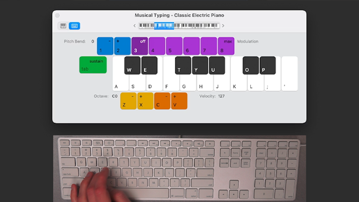 A screenshot of the Garageband interface while recording with Software Instruments, along with a computer keyboard and a hand using its keys.